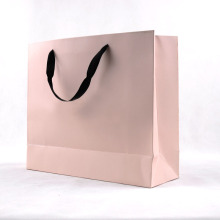 Elegante saco de compras de papel cartão rosa com alça